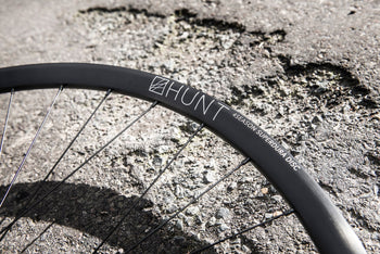 <h1>Rims</h1><i>A strong and lightweight 6061-T6 heat-treated rim features an asymmetric shape which is inverted from front to rear to provide balanced higher spoke tensions meaning your spokes stay tight for the long term. The rim profile is disc specific which allows higher-strength to weight as no reinforcement is required for a braking surface. The extra wide rim at 25mm (20mm internal) which creates a great tyre profile with wider 25-50mm tyres, giving excellent grip and lower rolling resistance.</i>