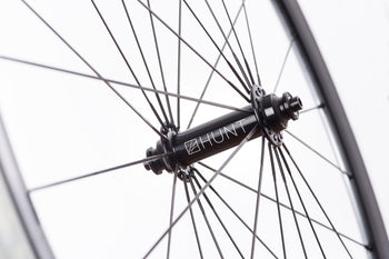 <h1>Hubs</h1><i>The hubs on the Race Aero SuperDura benefit from larger 12mm front and 15mm rear axles. This combined with them being machined from hard and strong 7075-T6 heat treated alloy means that they easily withstand the higher loads created by larger riders. Plus the cold forged then CNC machined hub shell means the metal grain structure is ideally aligned to handle the high spoke loads, the work hardening from the cold forging also adds extra strength.</i>